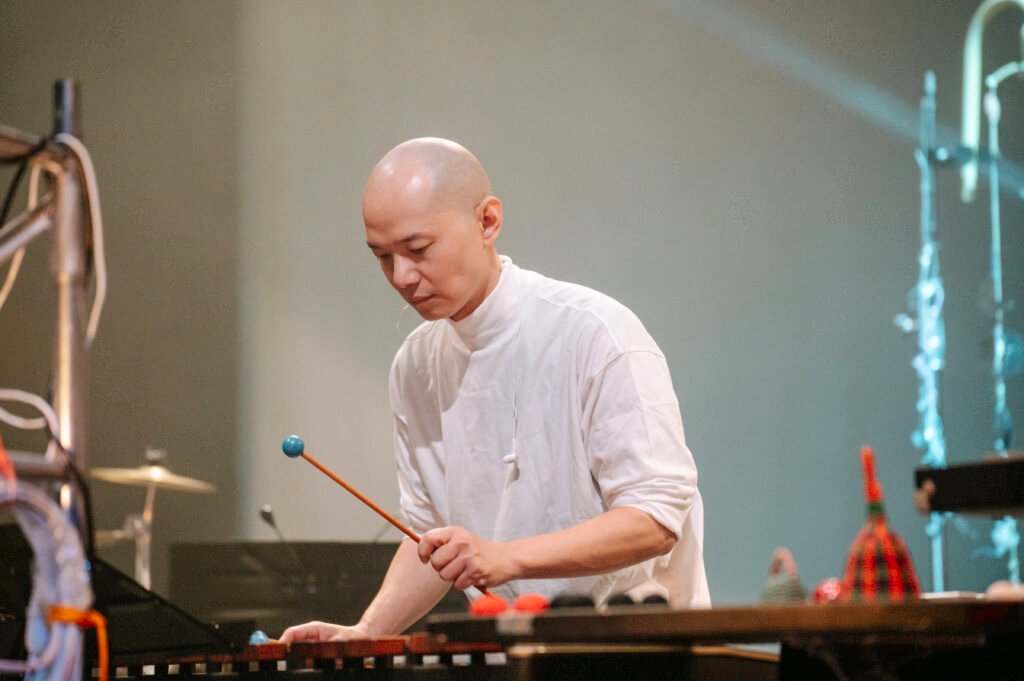 Percussionist and composer Bang-hau Liao performing with mallets on stage